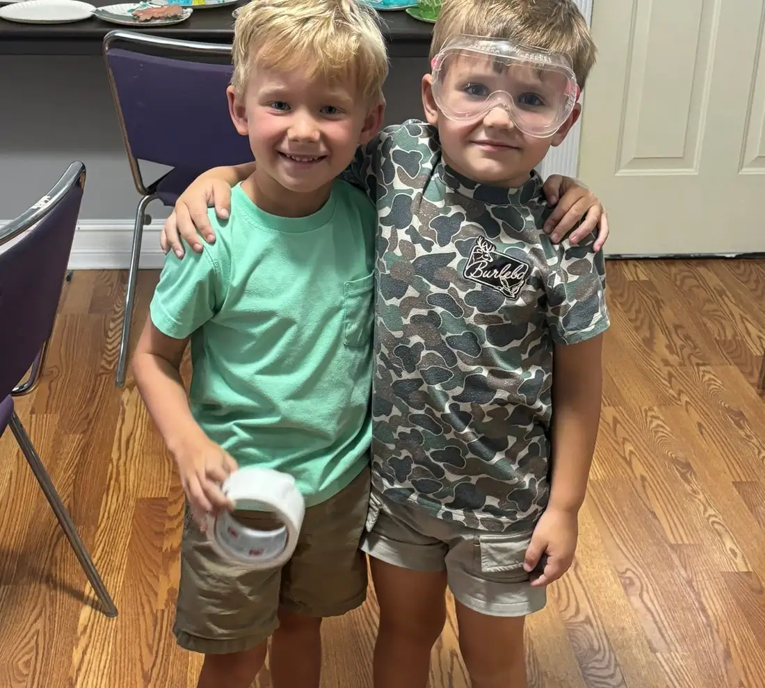 Two summer campers in safety goggles after a science activity