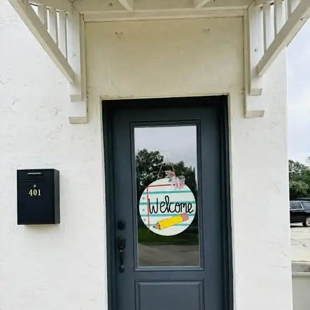 The front door of The Scholar Studio with a welcome wreath