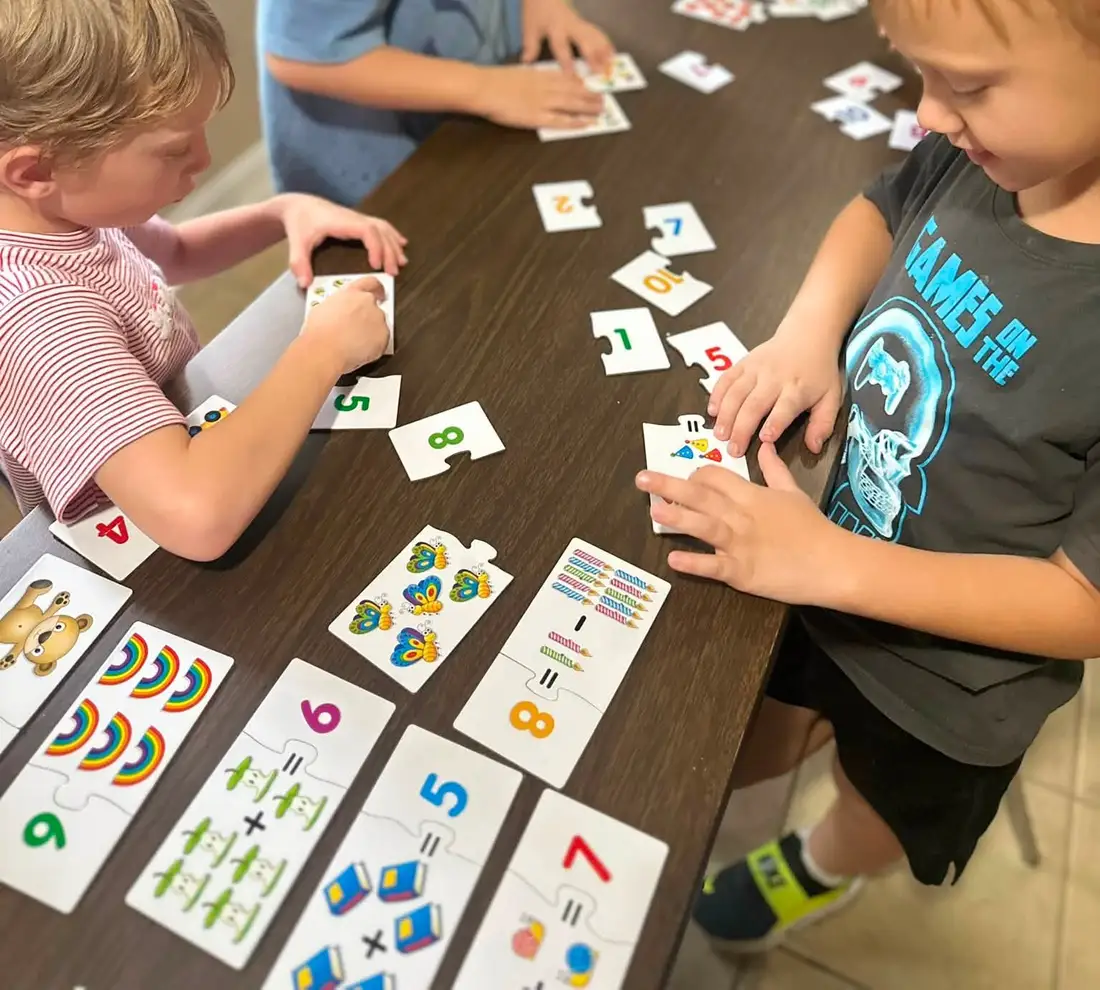 Students working with number and math cards at the studio table